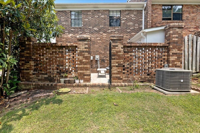 2920 Arrowhead Dr, Augusta, GA 30909 - view of front facade with cooling unit, brick siding, and a front lawn