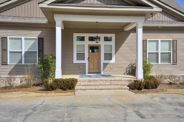 view of exterior entry with a porch