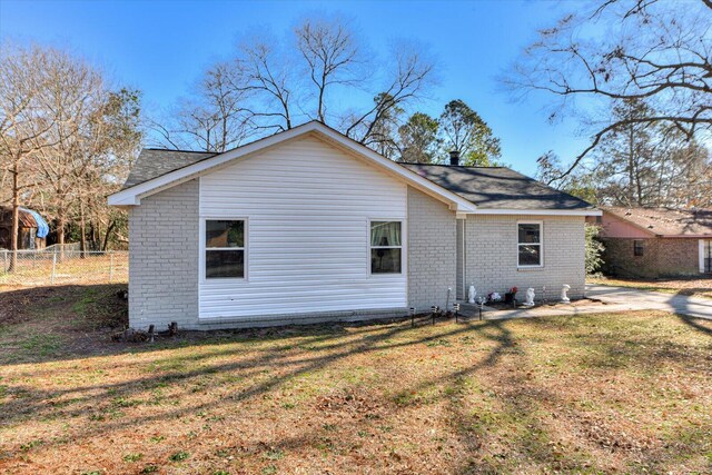 back of house featuring a yard and a patio area