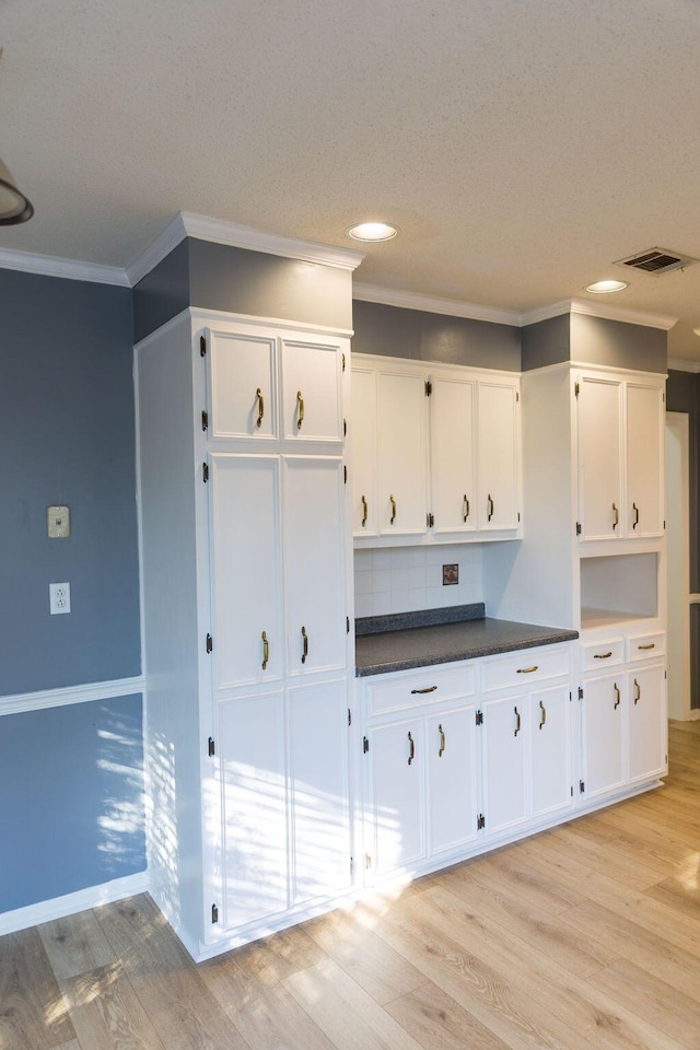 337 Patton Ct, Martinez, GA 30813 - kitchen with white cabinets, light wood-style flooring, ornamental molding, dark countertops, and recessed lighting
