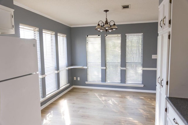 337 Patton Ct, Martinez, GA 30813 - unfurnished dining area featuring a chandelier, baseboards, ornamental molding, and light wood-style floors