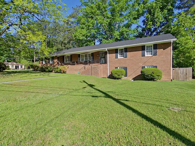 single story home with covered porch and a front lawn