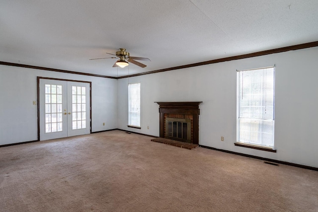 unfurnished living room with visible vents, ornamental molding, ceiling fan, and carpet floors