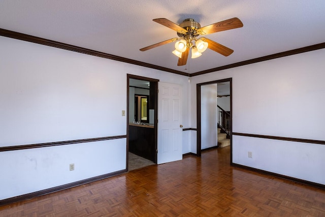 unfurnished room featuring baseboards, a textured ceiling, stairs, and a ceiling fan