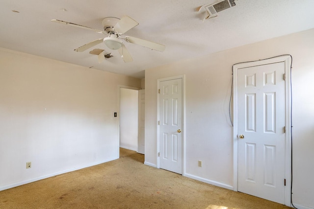 unfurnished bedroom with visible vents, baseboards, carpet, and ceiling fan