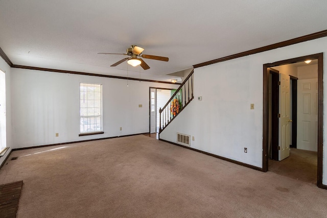 unfurnished living room with crown molding, carpet flooring, visible vents, and ceiling fan