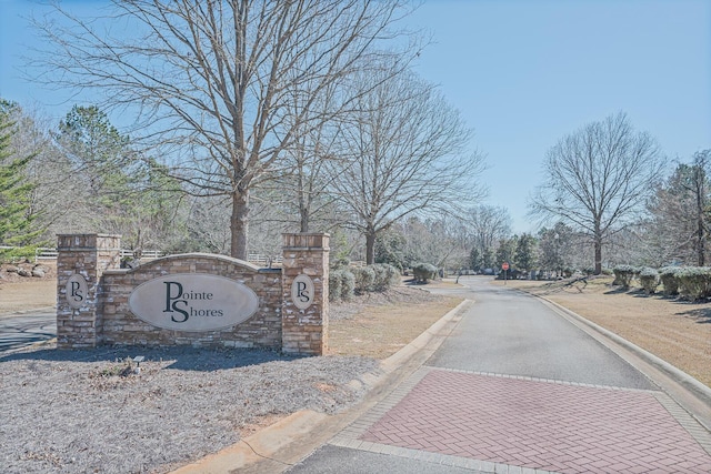 1021 S Pointe Ct, Tignall, GA 30668 - view of asphalt street with curbs, traffic signs, and view of scattered trees