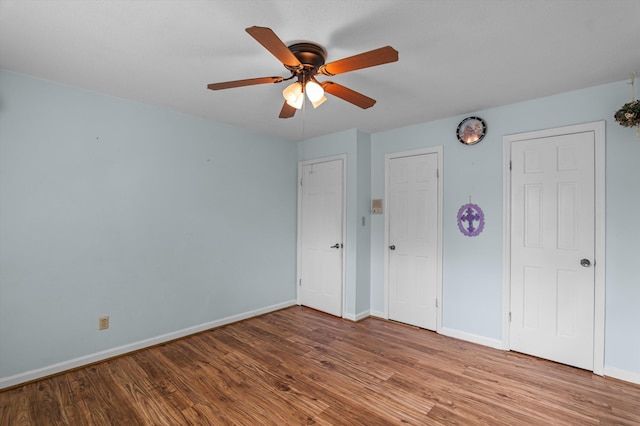 4558 Glenda Ln, Evans, GA 30809 - unfurnished bedroom with wood finished floors, baseboards, and a ceiling fan