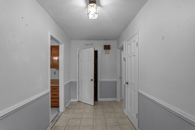 4558 Glenda Ln, Evans, GA 30809 - hall with a textured ceiling and light tile patterned floors