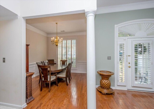 900 Mitchell Ln, Evans, GA 30809 - dining area featuring decorative columns, light wood-style flooring, plenty of natural light, a chandelier, and ornamental molding