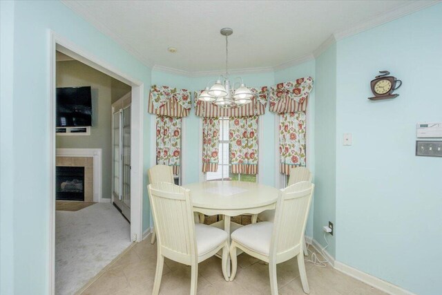900 Mitchell Ln, Evans, GA 30809 - dining area with a chandelier, ornamental molding, a tile fireplace, baseboards, and light colored carpet
