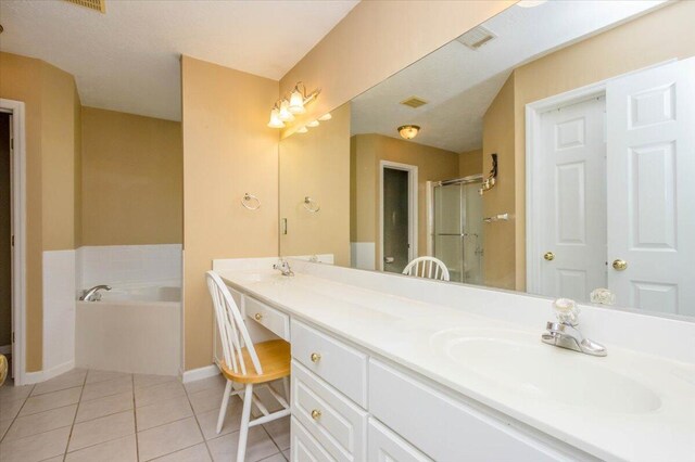 900 Mitchell Ln, Evans, GA 30809 - bathroom featuring tile patterned floors, a garden tub, double vanity, baseboards, and a stall shower