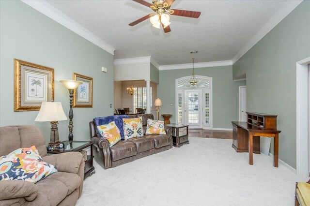 900 Mitchell Ln, Evans, GA 30809 - carpeted living room with crown molding, ceiling fan, a chandelier, and baseboards
