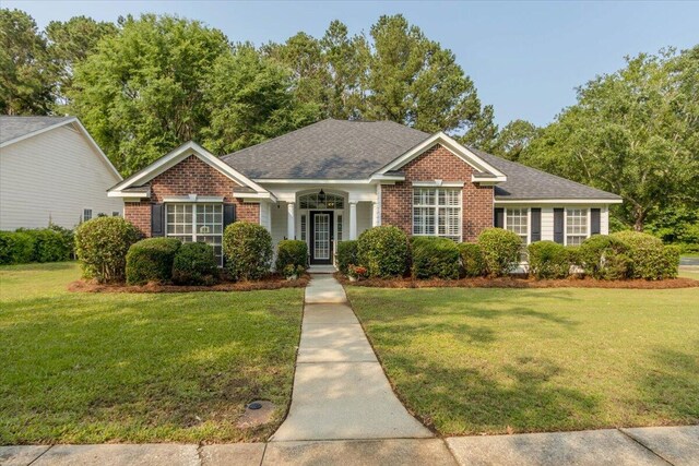900 Mitchell Ln, Evans, GA 30809 - view of front of home with brick siding, a front yard, and a shingled roof