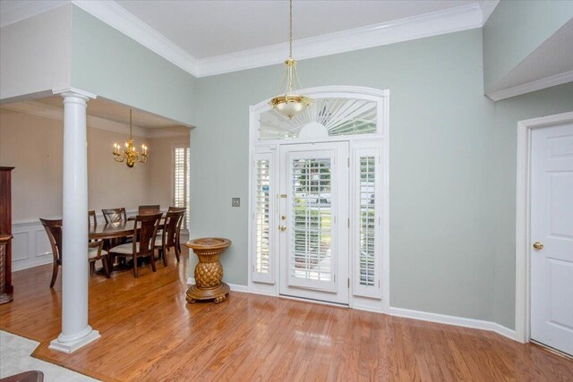 900 Mitchell Ln, Evans, GA 30809 - entryway with wood finished floors, decorative columns, a chandelier, crown molding, and baseboards