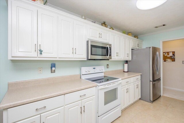 900 Mitchell Ln, Evans, GA 30809 - kitchen with stainless steel appliances, crown molding, white cabinetry, light countertops, and baseboards