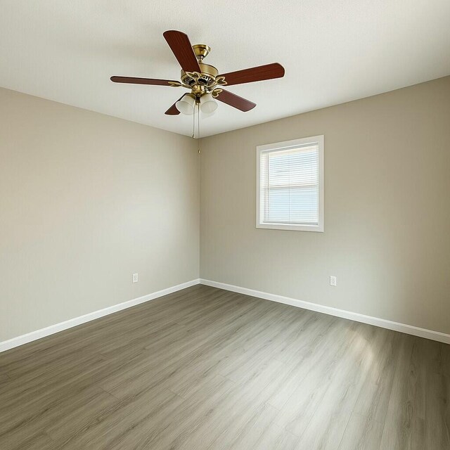 4612 Dunbarton Dr, Hephzibah, GA 30815 - unfurnished room with baseboards, a ceiling fan, and wood finished floors