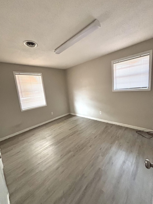 4612 Dunbarton Dr, Hephzibah, GA 30815 - empty room featuring visible vents, baseboards, wood finished floors, and a textured ceiling