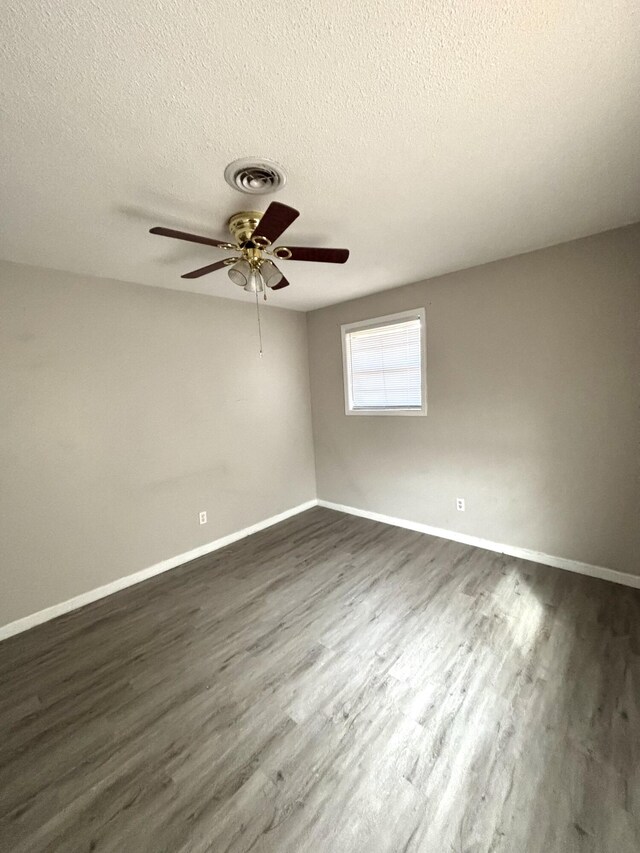 4612 Dunbarton Dr, Hephzibah, GA 30815 - unfurnished room featuring a textured ceiling, dark wood-style floors, and visible vents