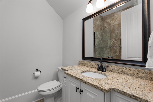 5099 Grande Park, Evans, GA 30809 - bathroom featuring baseboards, lofted ceiling, toilet, vanity, and tiled shower