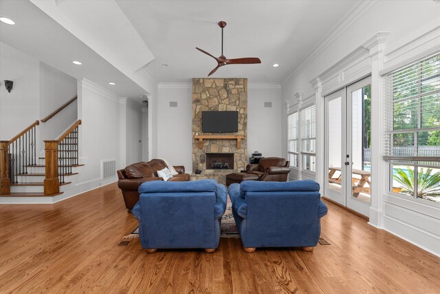 5099 Grande Park, Evans, GA 30809 - living room featuring light wood finished floors, crown molding, ceiling fan, a fireplace, and stairs