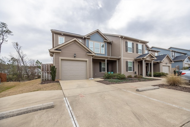 view of front of property featuring driveway and fence