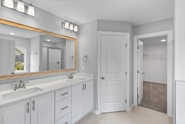 5051 Anna Way Unit Fb23, North Augusta, SC 29841 - bathroom featuring a stall shower, double vanity, a spacious closet, and tile patterned flooring
