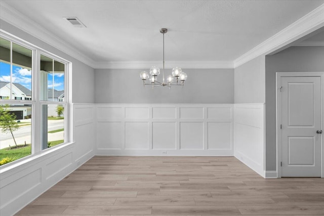 5051 Anna Way Unit Fb23, North Augusta, SC 29841 - unfurnished dining area with a decorative wall, healthy amount of natural light, a chandelier, ornamental molding, and light wood finished floors