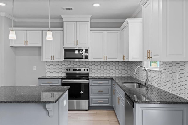 5051 Anna Way Unit Fb23, North Augusta, SC 29841 - kitchen with appliances with stainless steel finishes, white cabinetry, light wood-type flooring, hanging light fixtures, and crown molding