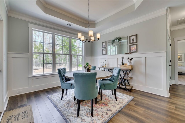 338 Pro Cir, Mccormick, SC 29835 - dining room featuring visible vents, a tray ceiling, dark wood-style flooring, a decorative wall, and a chandelier