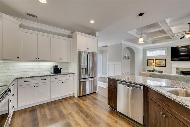 338 Pro Cir, Mccormick, SC 29835 - kitchen featuring visible vents, coffered ceiling, ornamental molding, white cabinets, and appliances with stainless steel finishes
