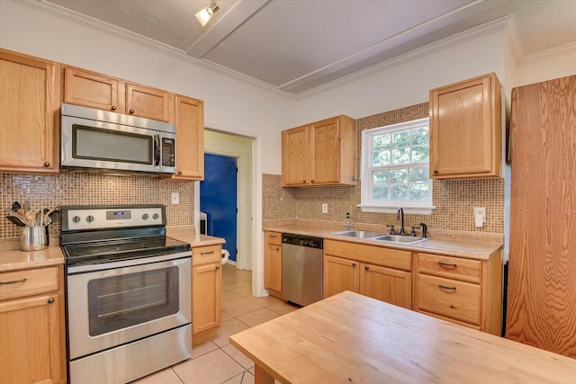 kitchen featuring light brown cabinetry, light tile patterned floors, sink, and appliances with stainless steel finishes