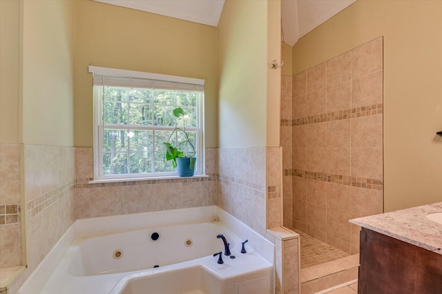 bathroom with vanity, tile walls, and independent shower and bath