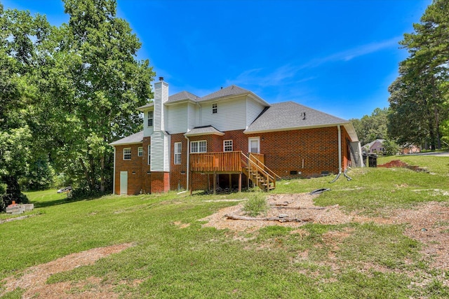 back of property featuring a lawn and a wooden deck