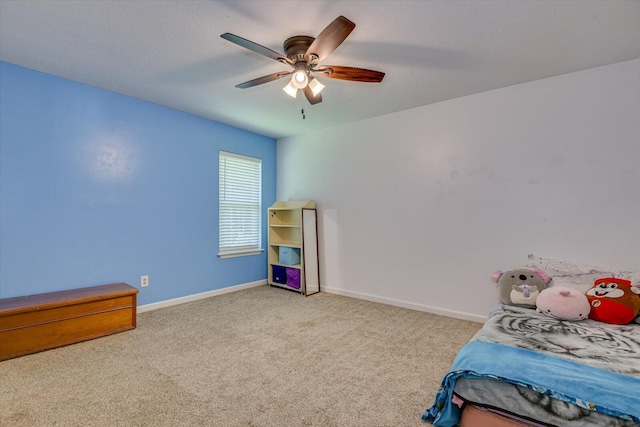 bedroom with ceiling fan and light carpet