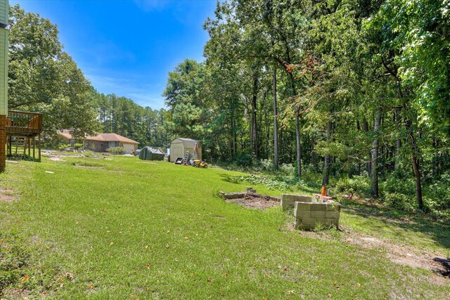 view of yard featuring a shed and a deck