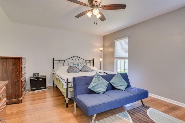 bedroom with hardwood / wood-style floors and ceiling fan