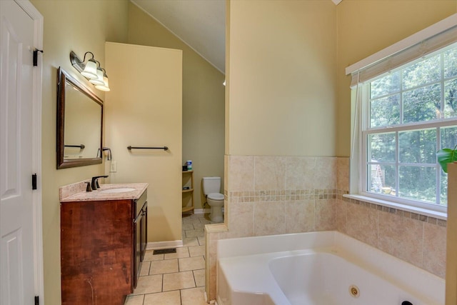 bathroom with vanity, a bathtub, lofted ceiling, tile patterned floors, and toilet