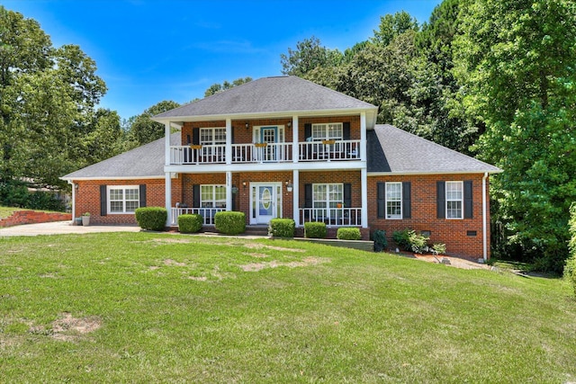 view of front of property with a porch, a balcony, and a front yard