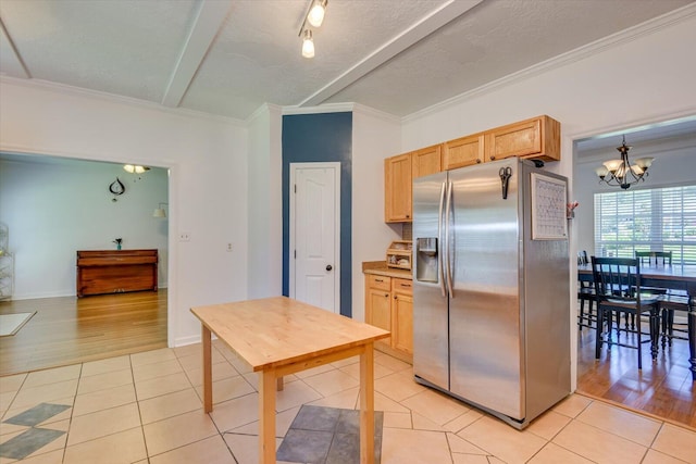 kitchen with a notable chandelier, stainless steel fridge, crown molding, pendant lighting, and light tile patterned floors