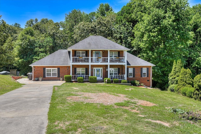 colonial-style house with a porch and a front lawn