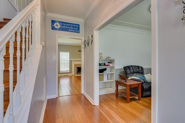 corridor featuring hardwood / wood-style flooring and ornamental molding