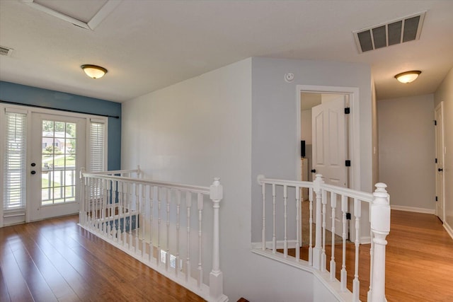 hall with hardwood / wood-style flooring