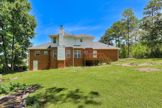 rear view of house with a lawn and a deck