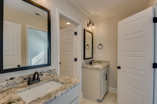 bathroom featuring vanity and hardwood / wood-style floors