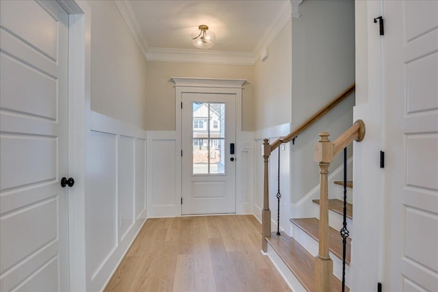 entrance foyer featuring crown molding and light hardwood / wood-style flooring