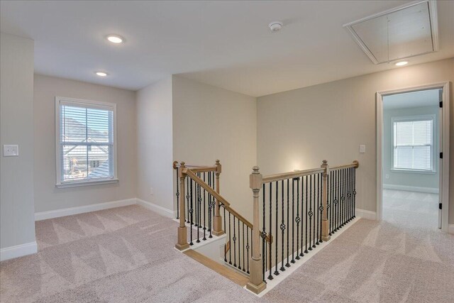 hallway featuring light colored carpet