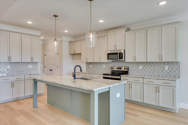 kitchen featuring crown molding, hanging light fixtures, stainless steel appliances, white cabinets, and light wood-type flooring