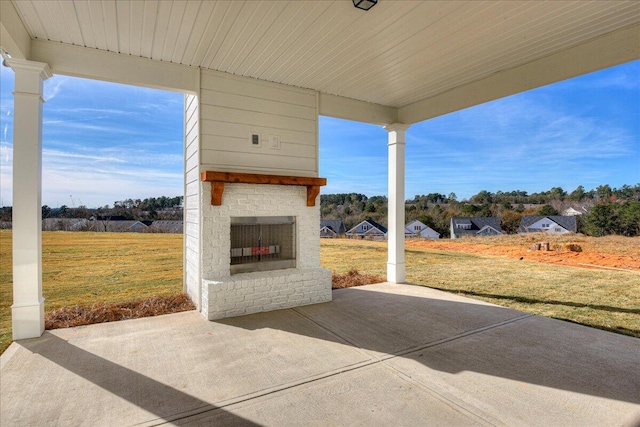 view of patio / terrace featuring an outdoor brick fireplace