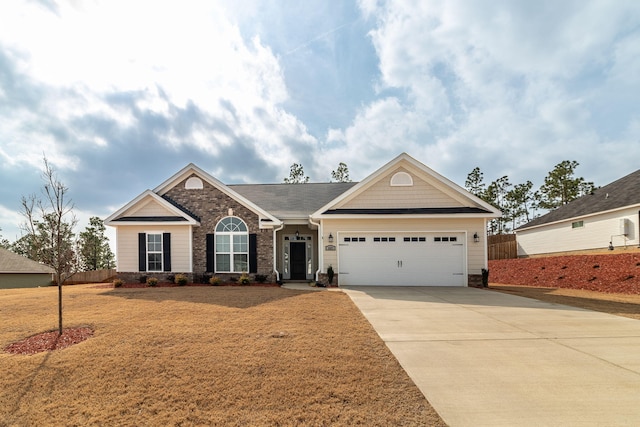 view of front of property featuring a garage and a front lawn